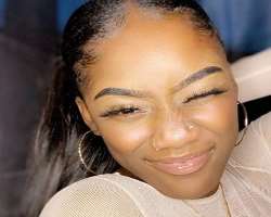 She has piercing on both sides of her nose and also in her ears.